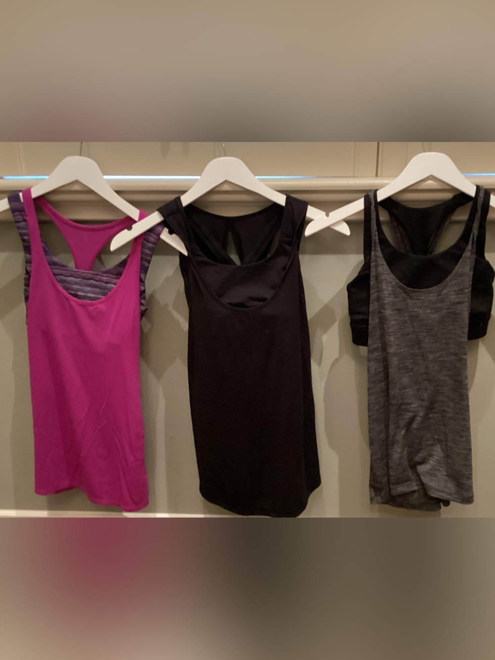 Three Lululemon tanks with built-in sports bra